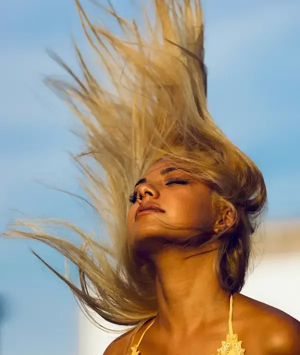 Woman throwing her hair back in the wind