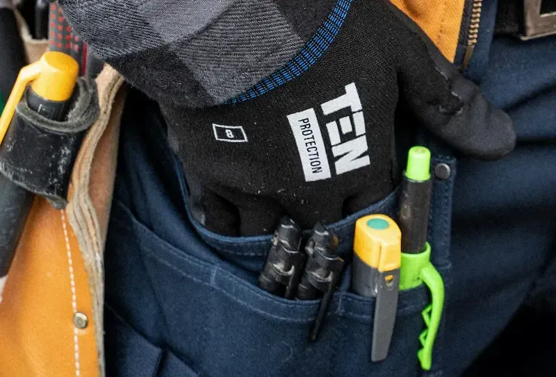 Installers hand in pocket with tools