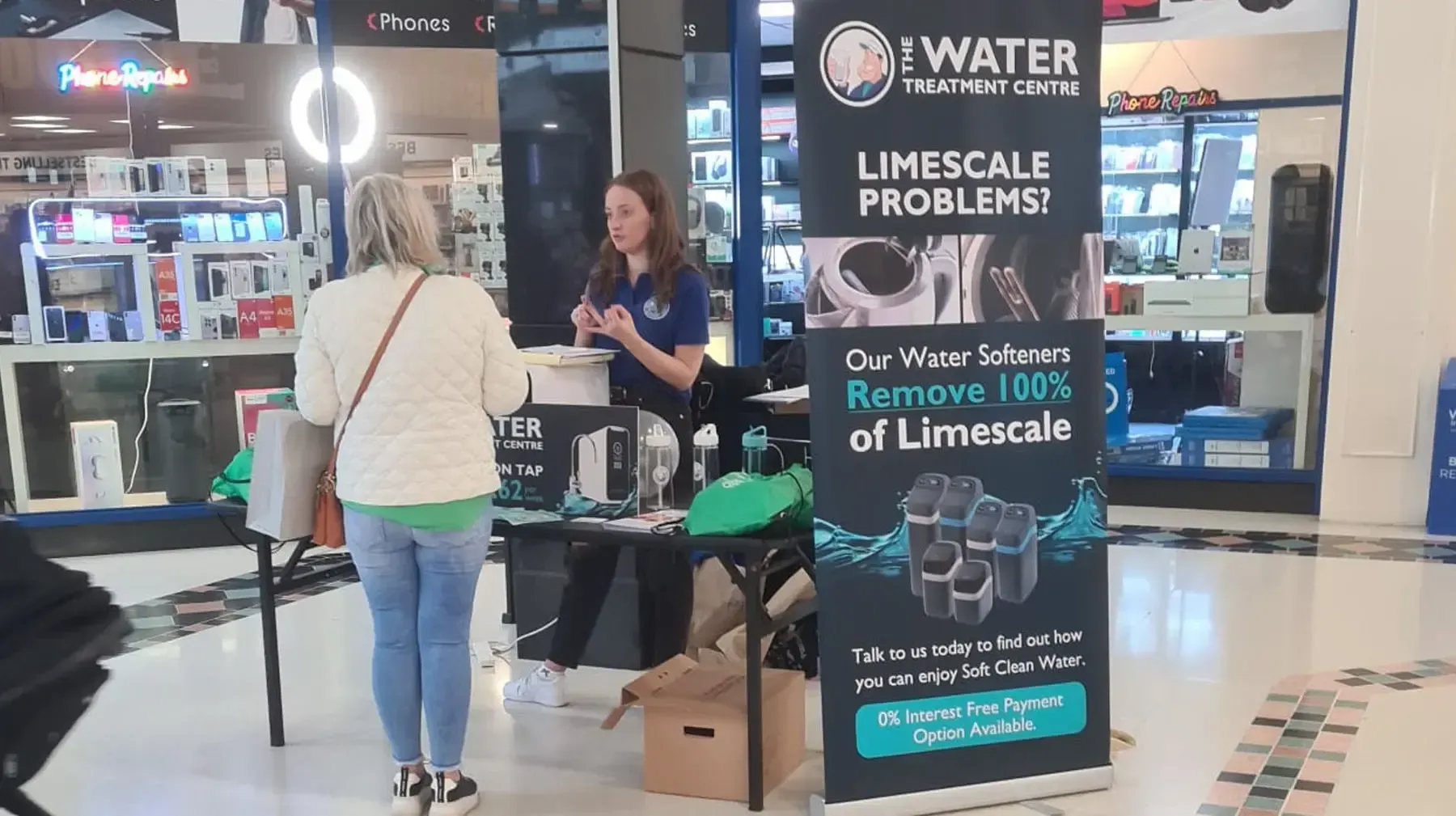 A Water Treatment Centre member of staff advising a customer