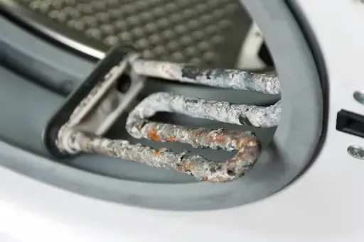 Limescale deposits on a washing machine heating element